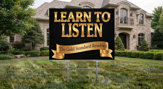 A yard sign with the text 'LEARN TO LISTEN' in large gold letters on a black background, with a banner reading 'The Gold Standard Resolved,' placed in a grassy lawn in front of a large stone house.