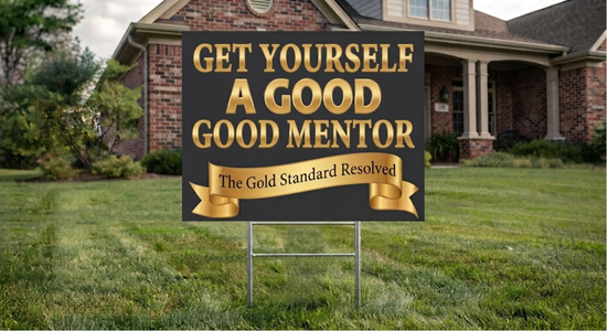 A yard sign in a grassy lawn in front of a brick house. The sign is black with large gold text reading &