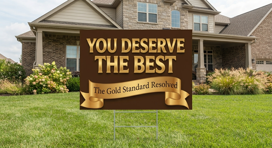 A brown yard sign with gold lettering that reads &