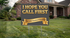 A yard sign with the text &